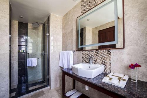 a bathroom with a sink and a shower at BW Plus Zanzibar in Zanzibar City