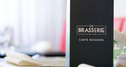 a table with a sign that reads la bravace cafe rooms at Best Western Hotel Wavre in Wavre