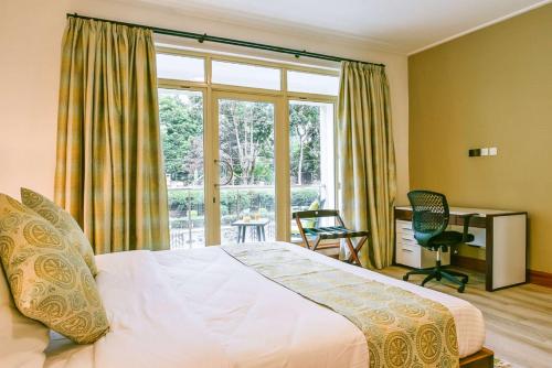 a bedroom with a bed and a large window at Executive Residency by Best Western Nairobi in Nairobi