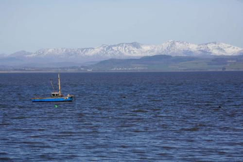 a blue boat in the middle of a large body of water at Best Western Lancaster Morecambe Lothersdale Hotel in Morecambe