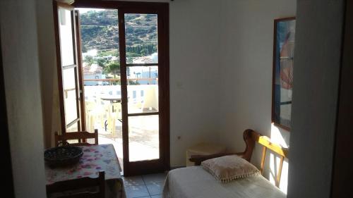 a room with a room with a window and a table at Elina Apartments in Batsi