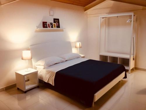 a bedroom with a bed and two lamps and a window at Palazzo di Fazio Suites in San Severo