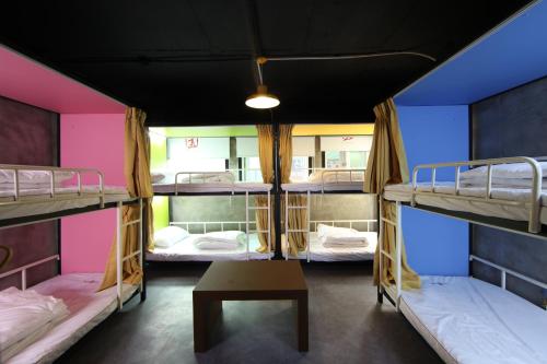 a group of bunk beds in a room at Calli Hostel in Busan