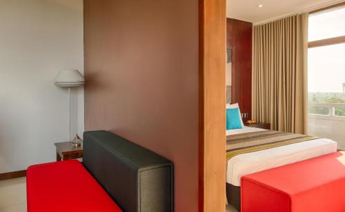 a hotel room with a bed and a tv at NorthGate Jaffna in Jaffna