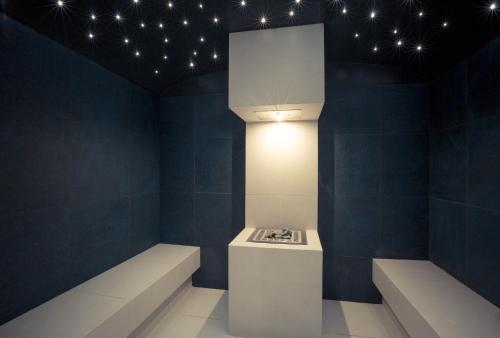 a room with blue walls and a light on the ceiling at Les Terrasses d'Eze - Hôtel & Spa in Èze