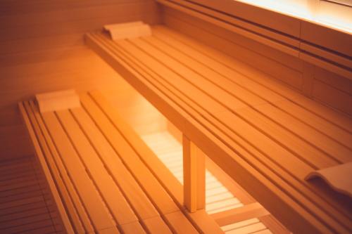 a wooden floor in a room with a bench at Les Terrasses d'Eze - Hôtel & Spa in Èze