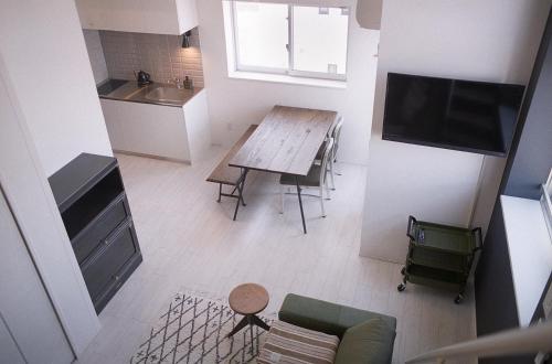 a small kitchen with a table and a dining room at AOCA Kaminoge 501 in Tokyo