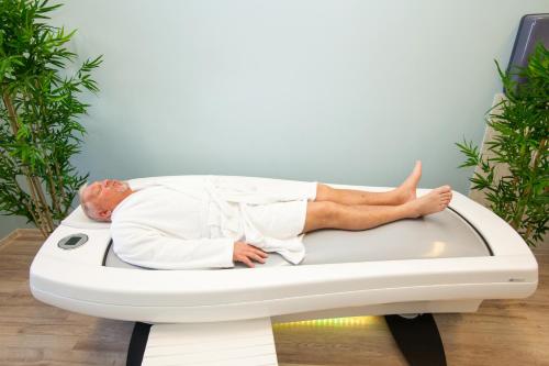 a man laying on a bed in a room at Viiking Spa Hotel in Pärnu