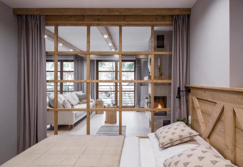 a bedroom with a bed and a fireplace at Apartamenty Chata Pod Reglami Zakopane in Zakopane