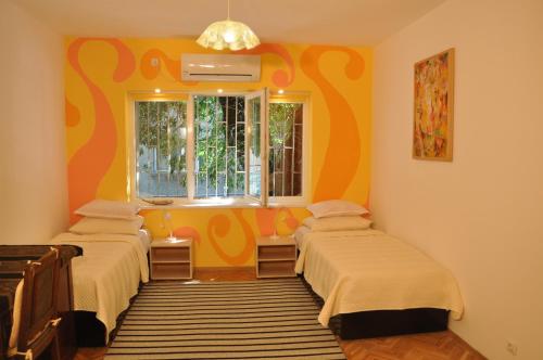 a room with two beds and a window at Arlequin Apartment in Varna City