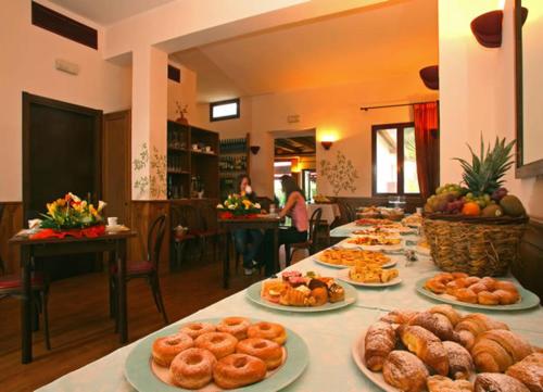 a table with many plates of food on it at Hotel Residence I Briganti di Capalbio in Capalbio
