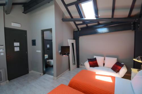a room with a bed and a couch and a bathroom at Familia in Vathi, Ithaka