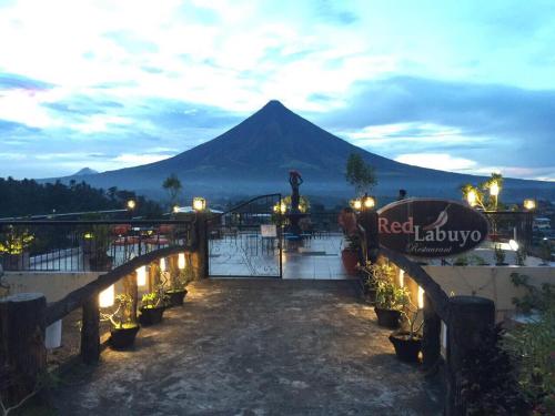 a mountain in the distance with a bridge and lights at Alta Residences in Daraga