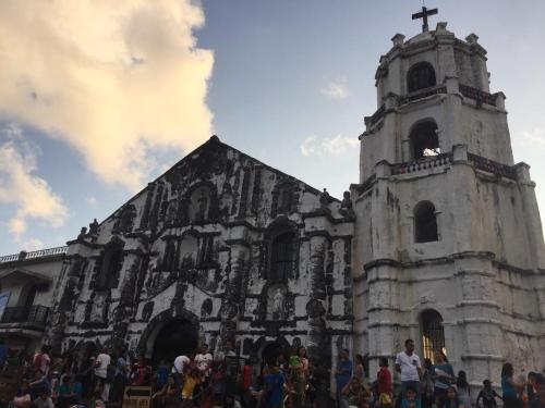 a group of people standing in front of a church at Alta Residences in Daraga