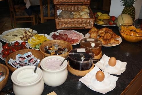 a table with many different types of food on it at Gasthaus Jaufenblick in San Martino