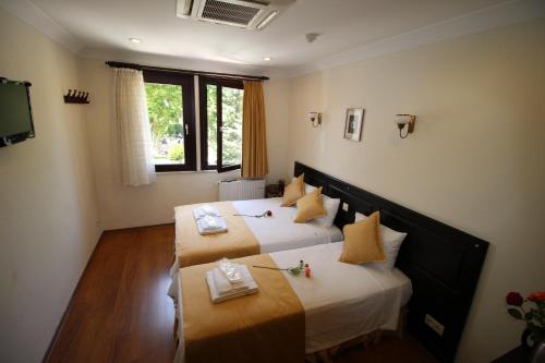 Katil atau katil-katil dalam bilik di Sultans Hotel