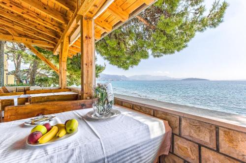 a table with a plate of fruit on top of it at Apartments & Bungalows Ivanović in Kaštela