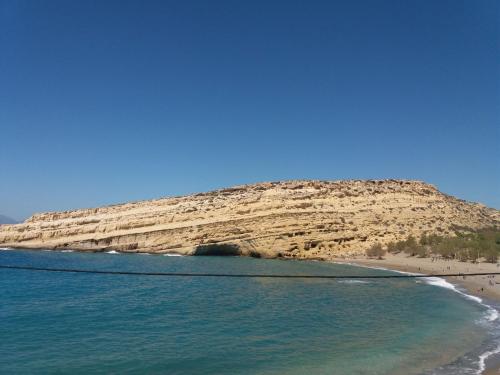 a view of a beach with a rocky mountain at Studio Rafaela in Matala