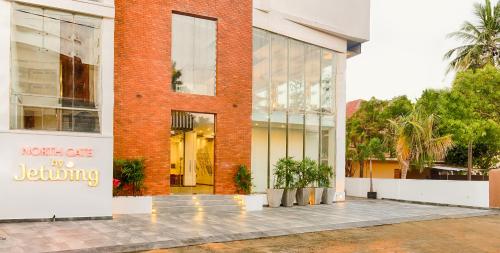 a red brick building with a sign in front of it at NorthGate Jaffna in Jaffna