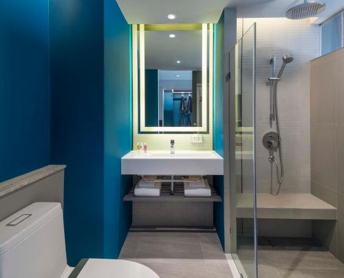 a bathroom with a sink and a shower at U Jomtien Pattaya in Jomtien Beach