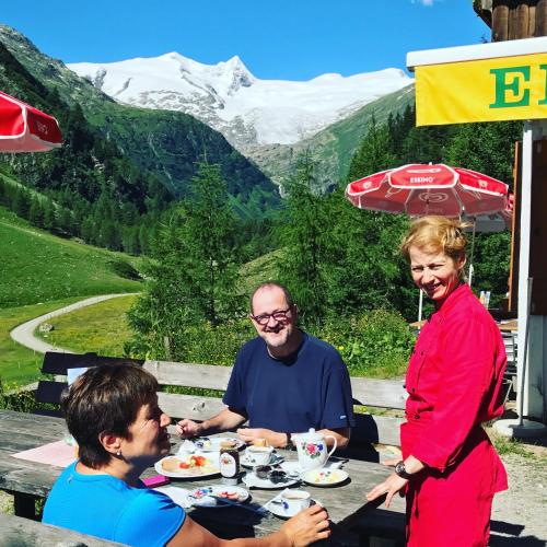 a group of people sitting at a table eating food at Berghaus Außergschlöß in Matrei in Osttirol