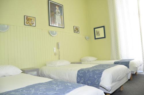 Katil atau katil-katil dalam bilik di Citotel Hôtel Cesar