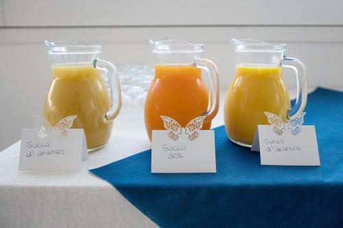 two mason jars of squeezed orange juice on a table at Hotel Ristorante Crescenzo in Procida