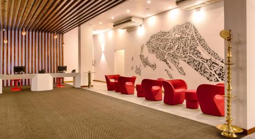 a waiting room with red chairs and a drawing on the wall at NorthGate Jaffna in Jaffna
