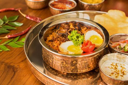 a bowl of food on a plate on a table at NorthGate Jaffna in Jaffna
