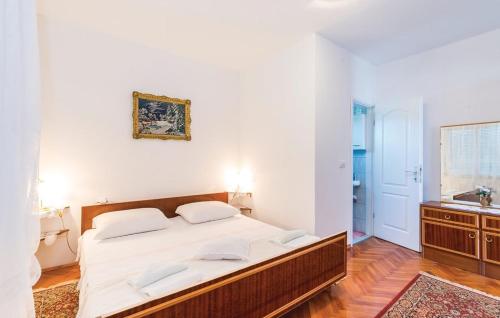 a bedroom with a large bed and a sink at Apartmani "PALMA" in Lun