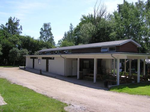 a building with a dirt road in front of it at Nivå Camping & Cottages in Nivå
