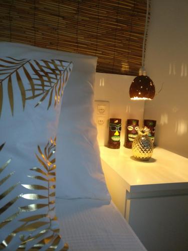 a bedroom with a bed with a white pillow and lights at Wonder Rooms Nerja Guest House in Nerja