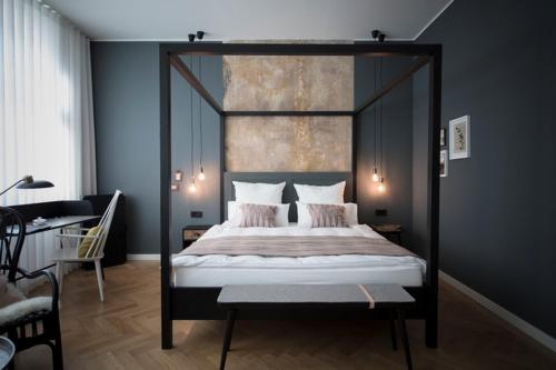 a bedroom with a canopy bed in a room at Villa Weiss in Helmbrechts