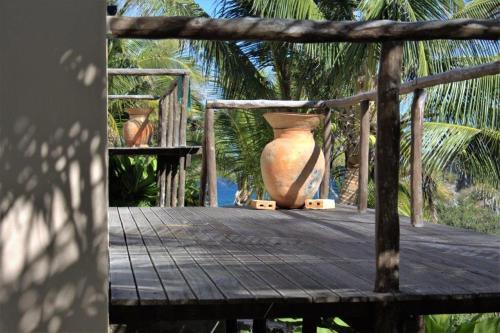a large vase sitting on top of a wooden table at Casa Malcampo in Praia do Tofo