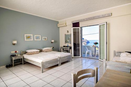 a bedroom with a bed and a view of the ocean at Artemis Studios in Plakias