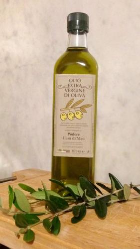 a bottle of wine sitting on a wooden table at Casa di Meo in Buti