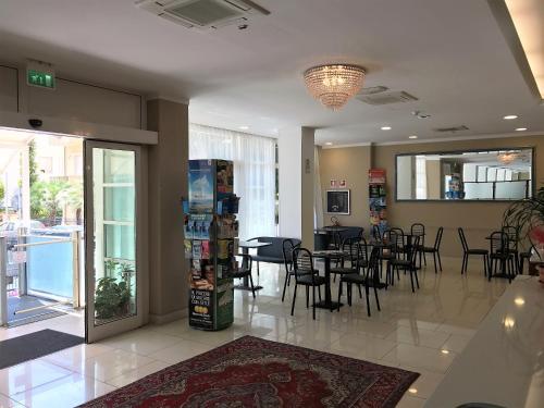 a restaurant with a dining room with tables and chairs at Hotel Boom in Rimini