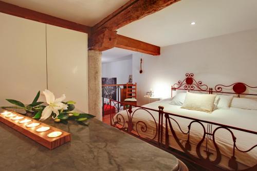 a bedroom with a bed and a table with lights at Ca' Cortigiane Suite in Venice