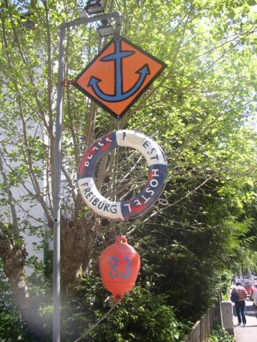 a group of signs hanging from a street light at Black Forest Hostel in Freiburg im Breisgau