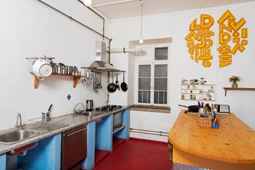 a kitchen with a wooden counter top and a wooden table at Black Forest Hostel in Freiburg im Breisgau