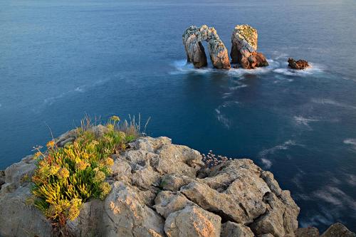 a group of rocks in the water near the ocean at Casa Boo de Piélagos - Playa de Liencres in Boó de Piélagos