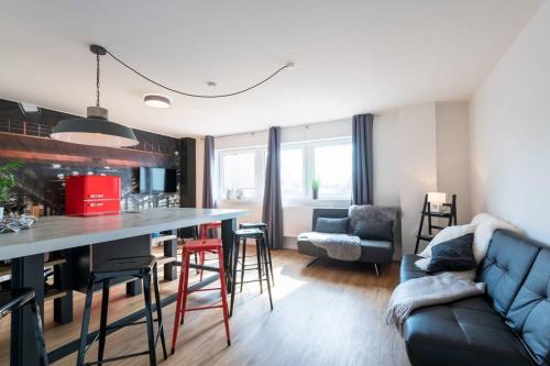 a kitchen and living room with a bar and a couch at Exklusive Design Erlebnisferienwohnung in Bad Wörishofen