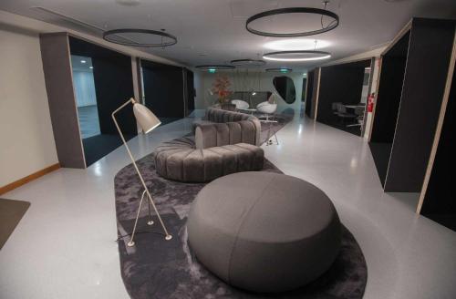 a living room with two chairs and a couch and a table at Azoris Angra Garden – Plaza Hotel in Angra do Heroísmo