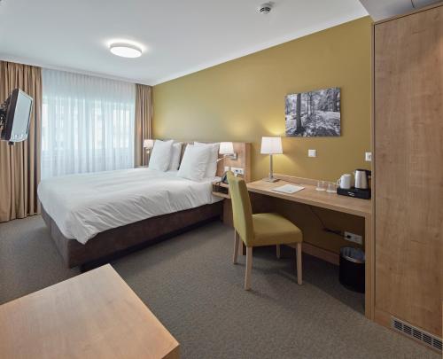 Säng eller sängar i ett rum på City Hotel