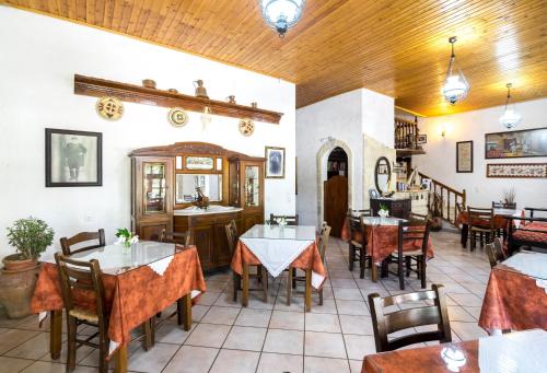 a restaurant with tables and chairs in a room at Keramos in Zaros