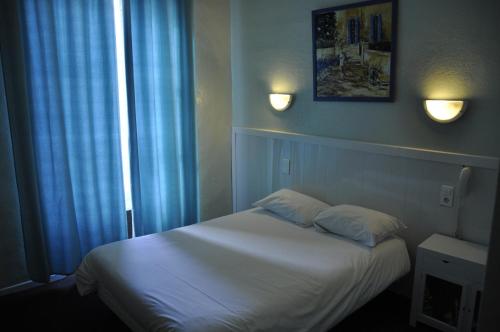 Katil atau katil-katil dalam bilik di Citotel Hôtel Cesar