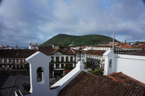 a view of a town with a mountain in the background at Azoris Angra Garden – Plaza Hotel in Angra do Heroísmo
