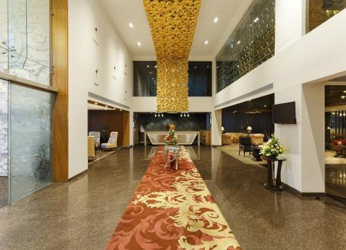 a lobby with a long red carpet in a building at La Marvella, Bengaluru in Bengaluru
