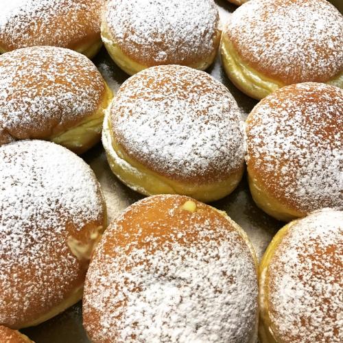 a bunch of donuts with powdered sugar on them at Hotel Boom in Rimini