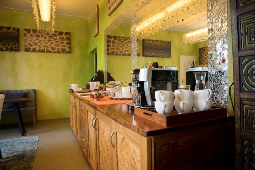 a kitchen with a counter with cups on it at No1 Art B&B in Au